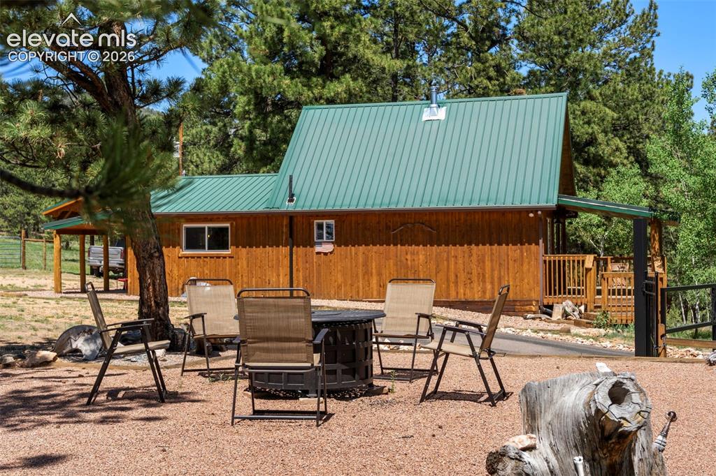 546 Pulver Road Lake George, CO 80827 - Photo 23 of 45 an outdoor sitting area with couch and umbrella