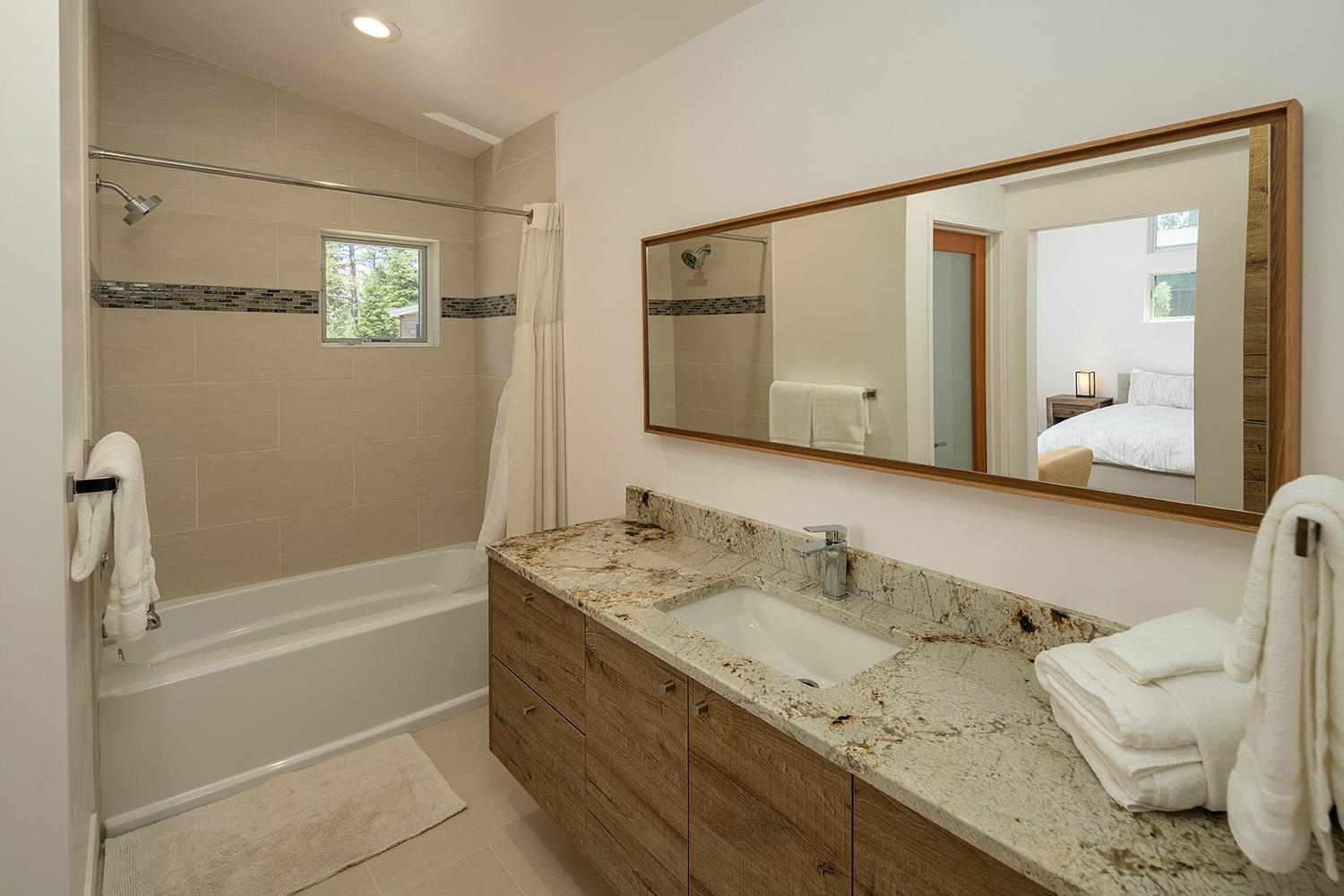 120 Smiley Circle Olympic Valley, CA 96146 - Photo 14 of 21 a bathroom with a granite countertop sink mirror and a bathtub
