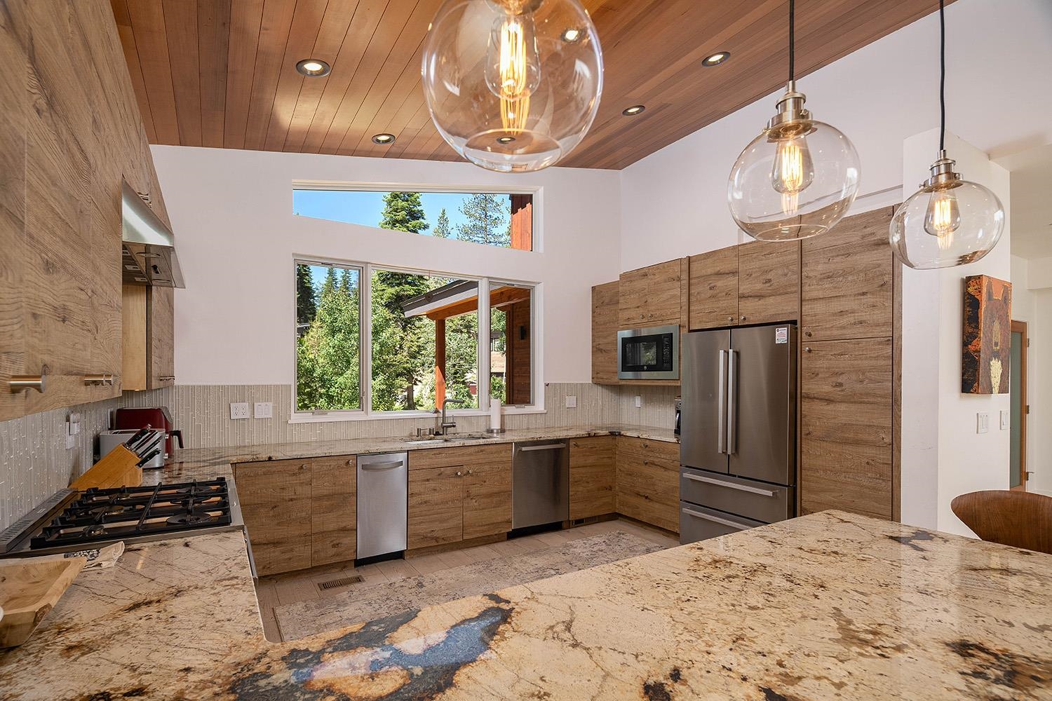 120 Smiley Circle Olympic Valley, CA 96146 - Photo 6 of 21 a kitchen with stainless steel appliances kitchen island granite countertop a refrigerator and a stove top oven