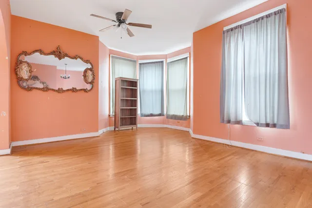 an empty room with windows and closet