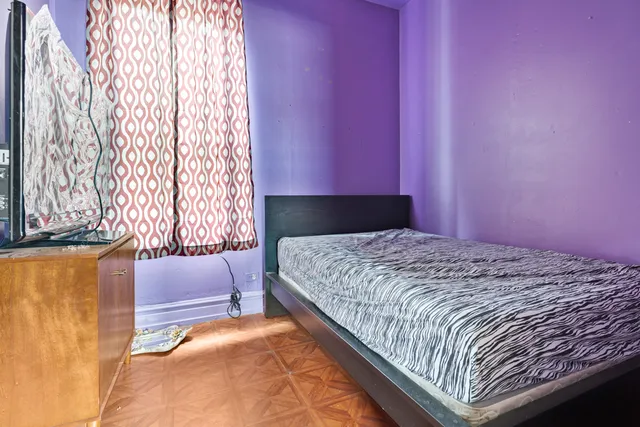 a bedroom with a bed and a window with outer view