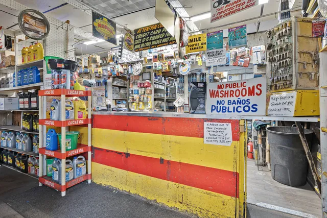 a room with lots of books and a refrigerator