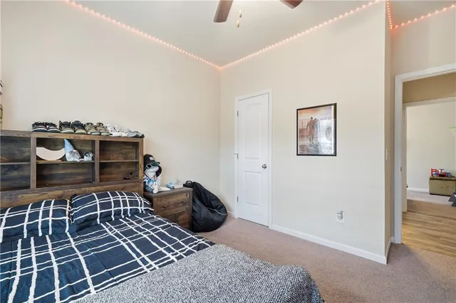 a bedroom with furniture and a flat screen tv