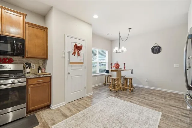 a kitchen with refrigerator and cabinets