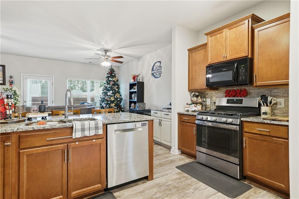 16 Brandon Lane Rome, GA 30165 - Photo 22 of 37 a kitchen with cabinets a sink and stainless steel appliances