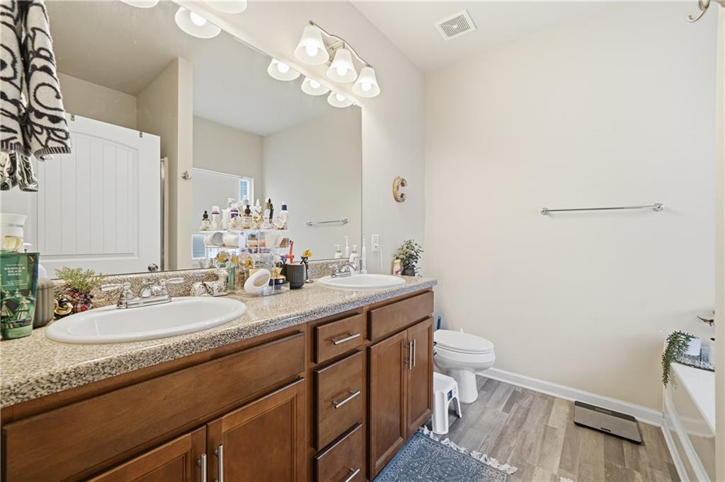 16 Brandon Lane Rome, GA 30165 - Photo 29 of 37 a bathroom with a granite countertop sink a toilet and a mirror
