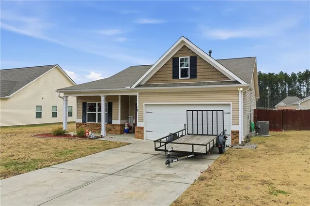 a view of a house with backyard and sitting area