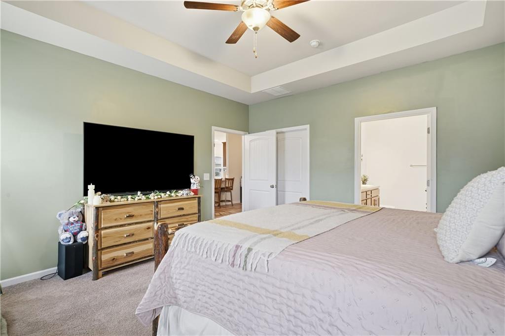 16 Brandon Lane Rome, GA 30165 - Photo 33 of 37 a bedroom with a bed and a flat tv screen on dresser