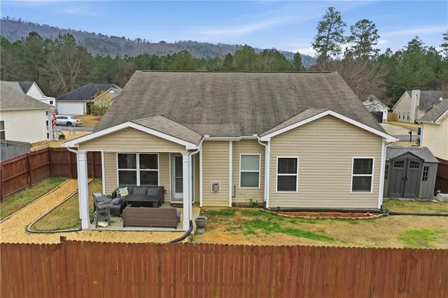 a view of a house with a yard and sitting area