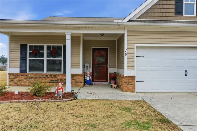 a hallway with beautiful frames and flower vase