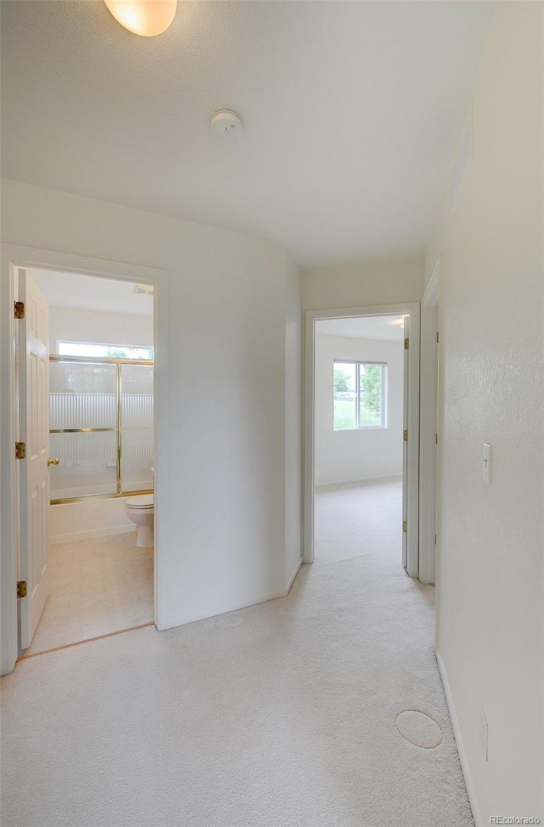 1237 Trail Ridge Road Longmont, CO 80504 - Photo 12 of 34 an empty room with windows and closet