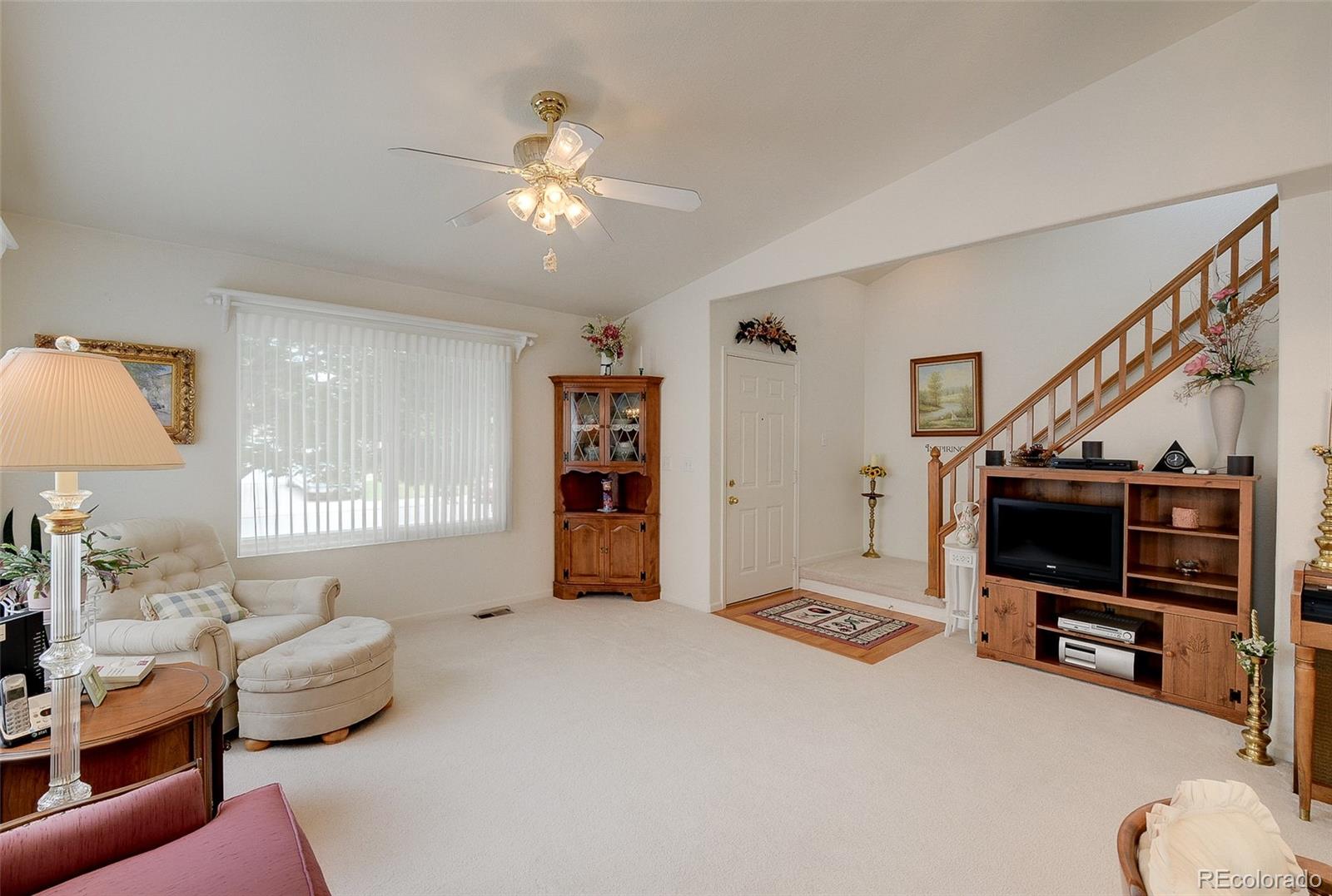 1237 Trail Ridge Road Longmont, CO 80504 - Photo 5 of 34 a living room with furniture and a flat screen tv