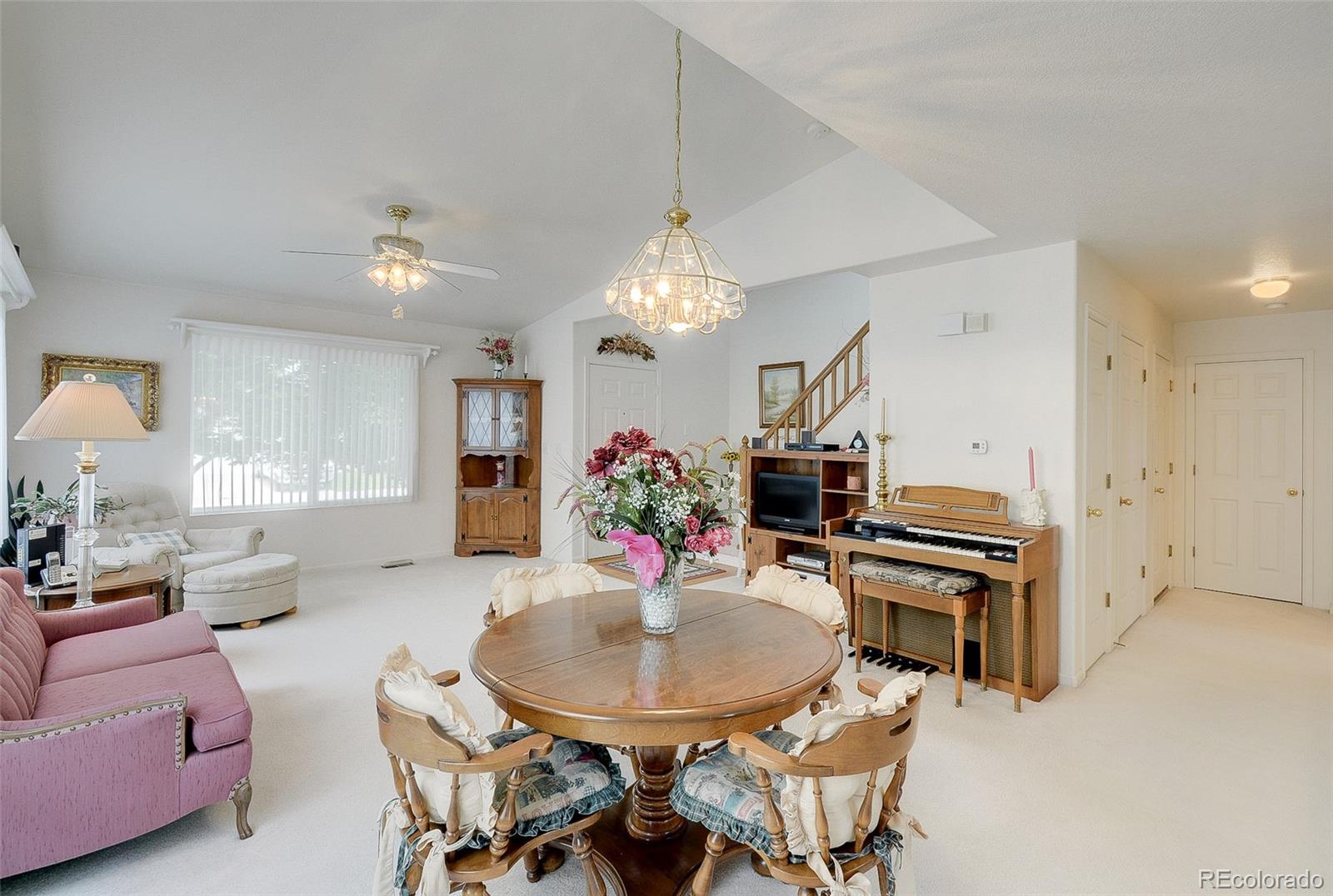 1237 Trail Ridge Road Longmont, CO 80504 - Photo 8 of 34 a view of a dining room with furniture and a chandelier