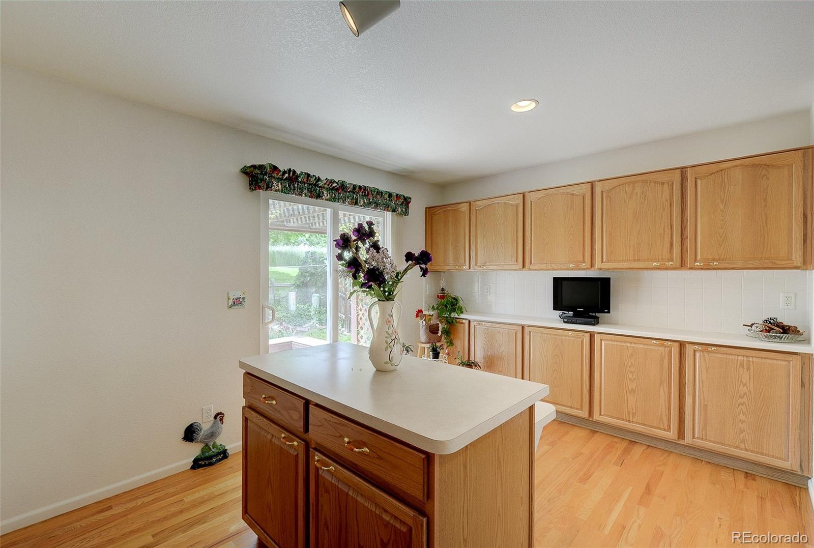 1237 Trail Ridge Road Longmont, CO 80504 - Photo 10 of 34 a kitchen with a sink cabinets and wooden floor