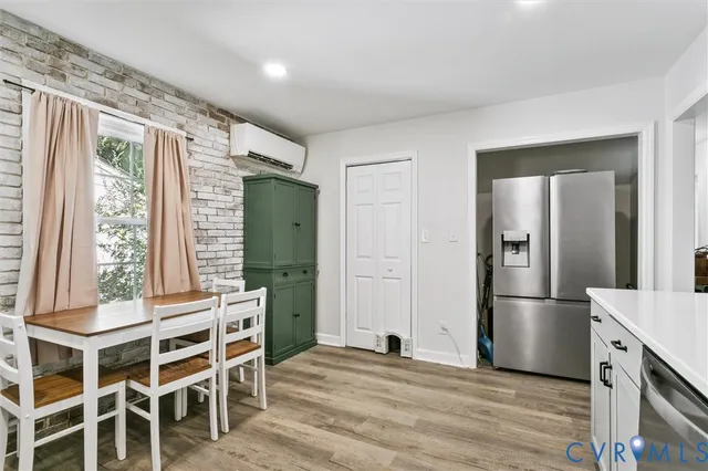 a view of a kitchen with furniture and wooden floor