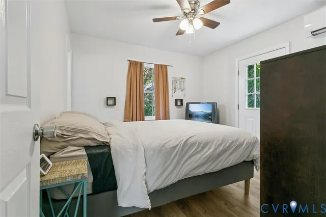 a bedroom with a bed and a chandelier