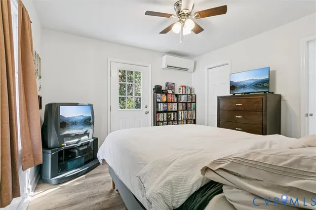 a bedroom with a bed and a television