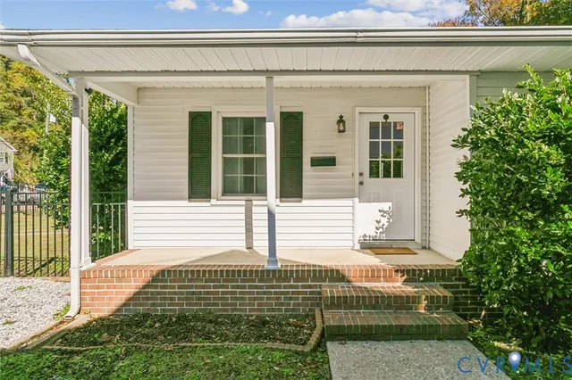 a front view of a house with a garden and plants