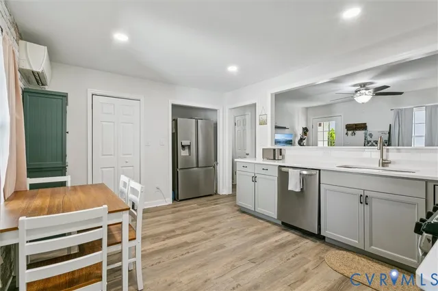 a room with a sink cabinets and wooden floor
