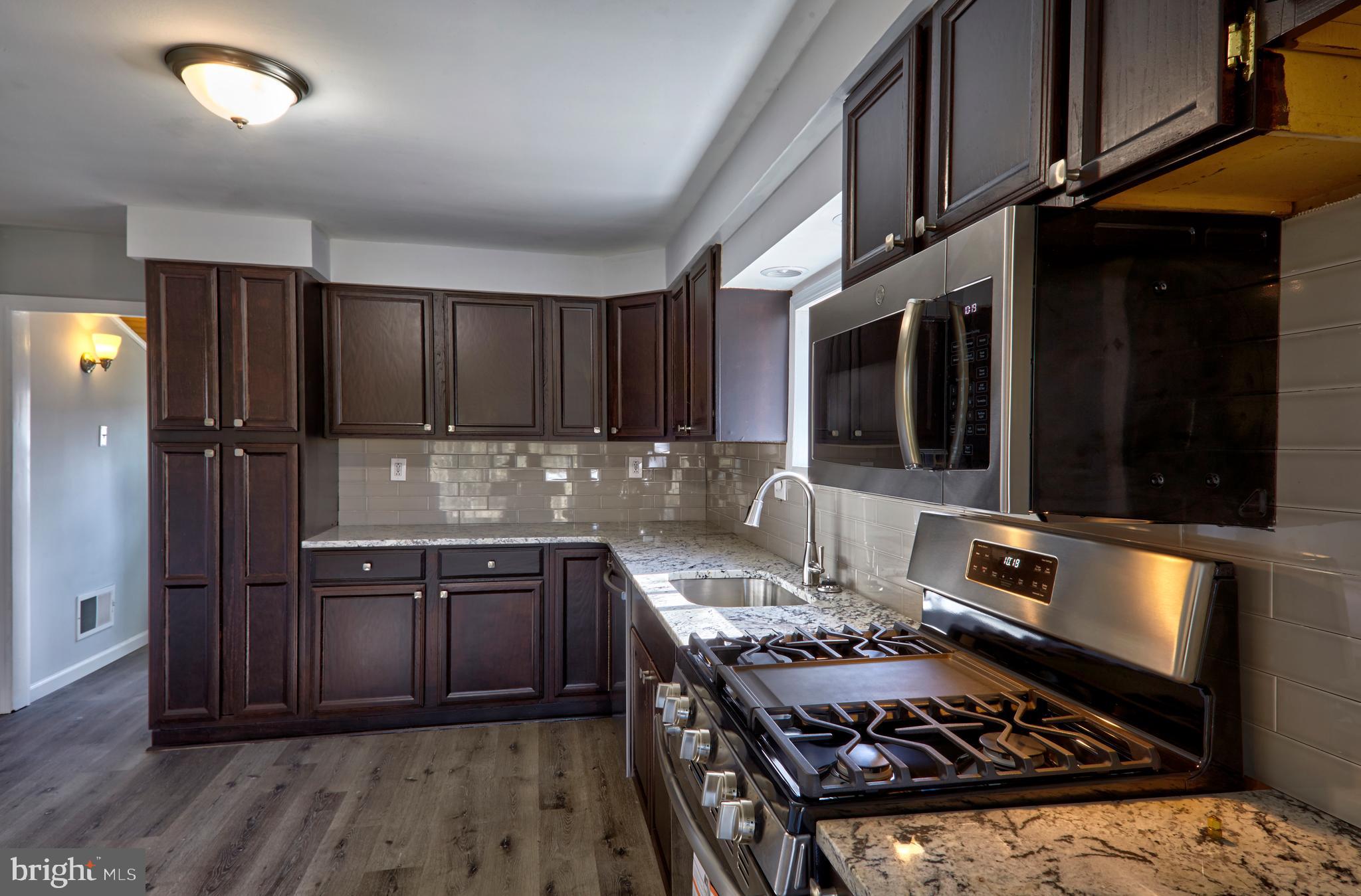 44 Cedarbrook Road Sicklerville, NJ 08081 - Photo 3 of 25 a kitchen with wooden cabinets and a stove top oven