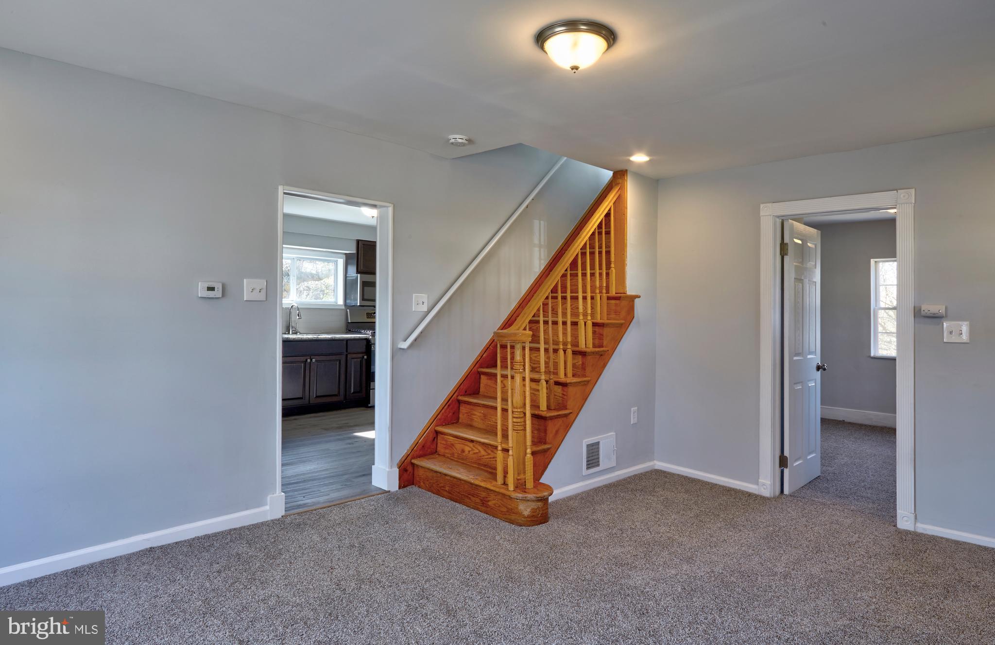 44 Cedarbrook Road Sicklerville, NJ 08081 - Photo 9 of 25 an empty room with staircase and a fireplace