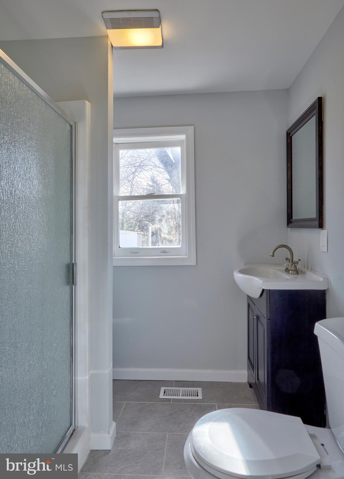 44 Cedarbrook Road Sicklerville, NJ 08081 - Photo 10 of 25 a bathroom with a toilet a sink and mirror