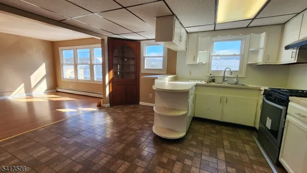 a kitchen with a sink and a stove top oven