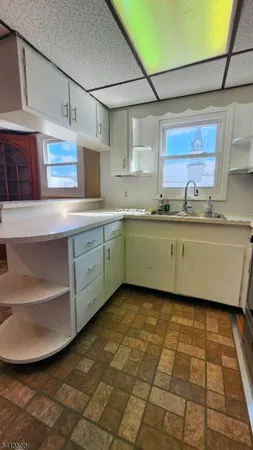 a kitchen with stainless steel appliances granite countertop a sink and cabinets