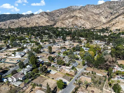 an aerial view of residential houses with a city street view