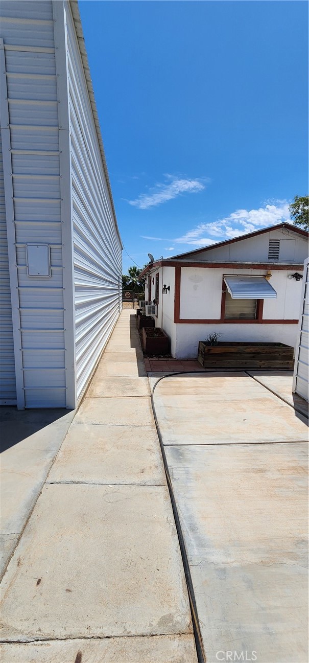 5120 Colorado River Road Blythe, CA 92225 - Photo 15 of 57 Walkway between RV garage and primary house, toward front yard and river