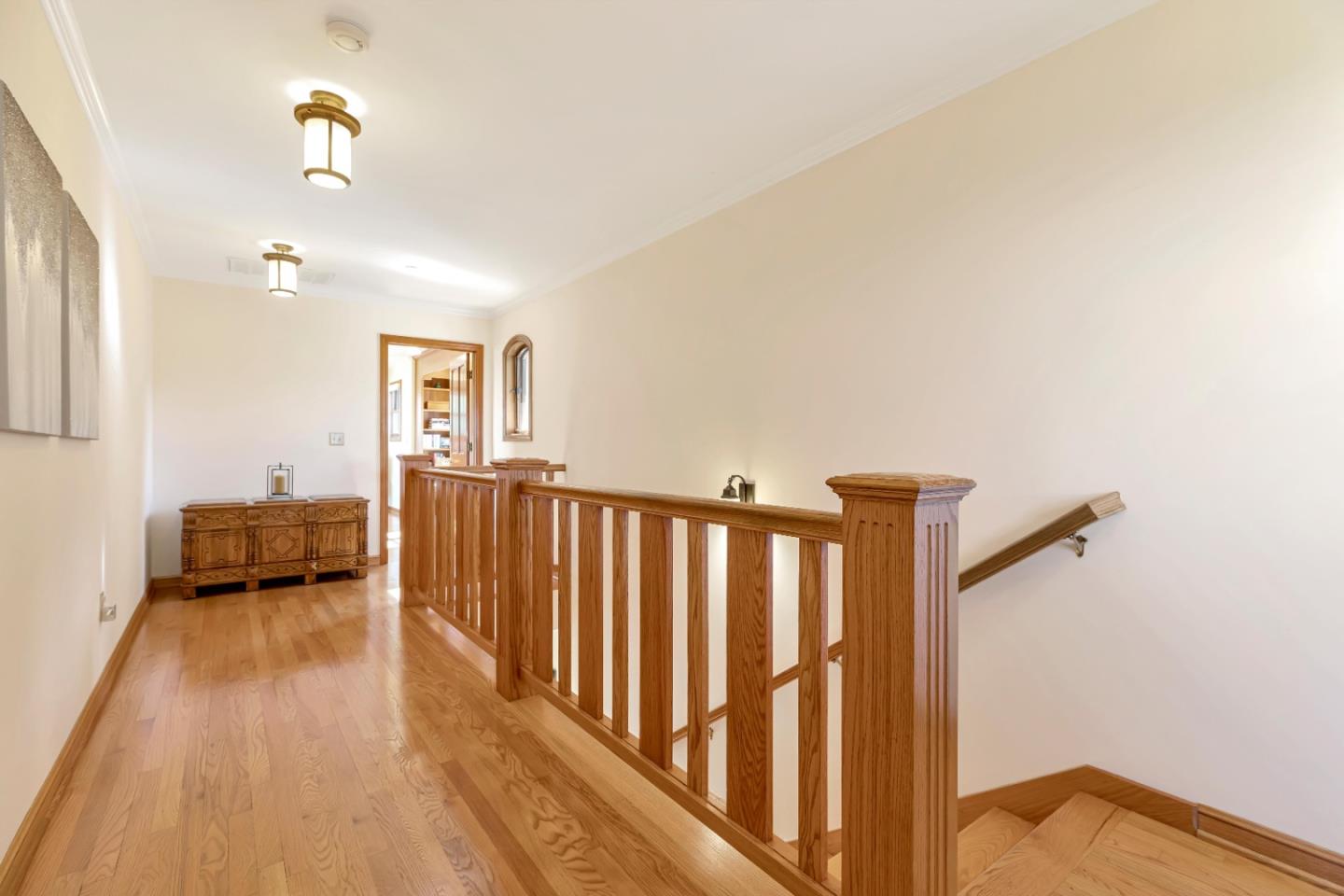 22820 San Juan Road Cupertino, CA 95014 - Photo 21 of 100 a view of a hallway with wooden floor and furniture