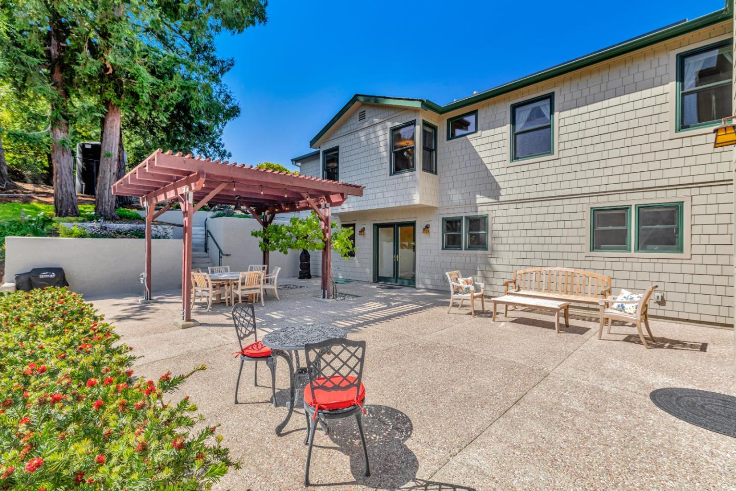 22820 San Juan Road Cupertino, CA 95014 - Photo 51 of 100 a patio with a table and chairs under an umbrella