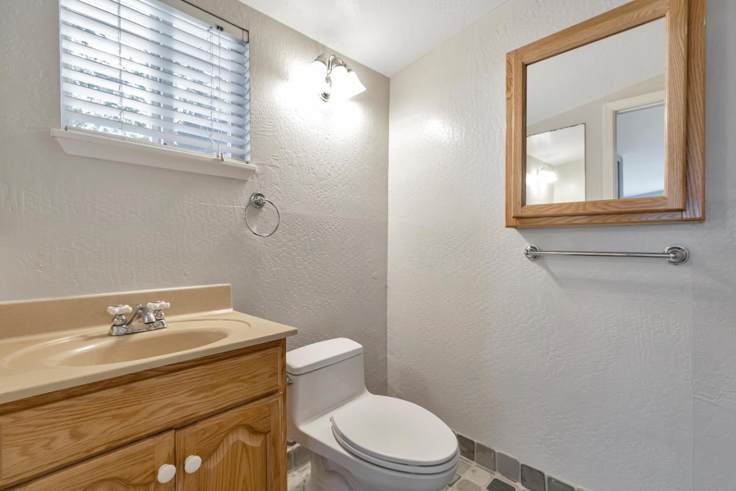 22820 San Juan Road Cupertino, CA 95014 - Photo 79 of 100 a bathroom with a toilet a sink and mirror