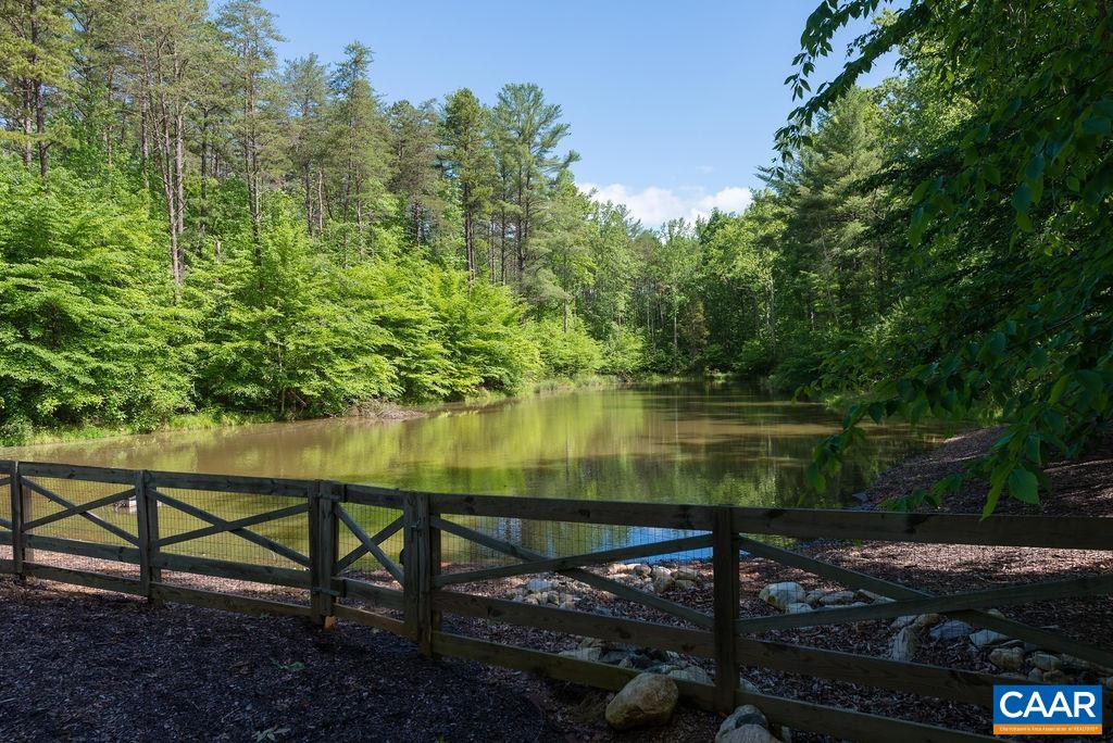 4051 Ballards Mill Road Free Union, VA 22940 - Photo 4 of 49 a wooden bench sitting next to a lake
