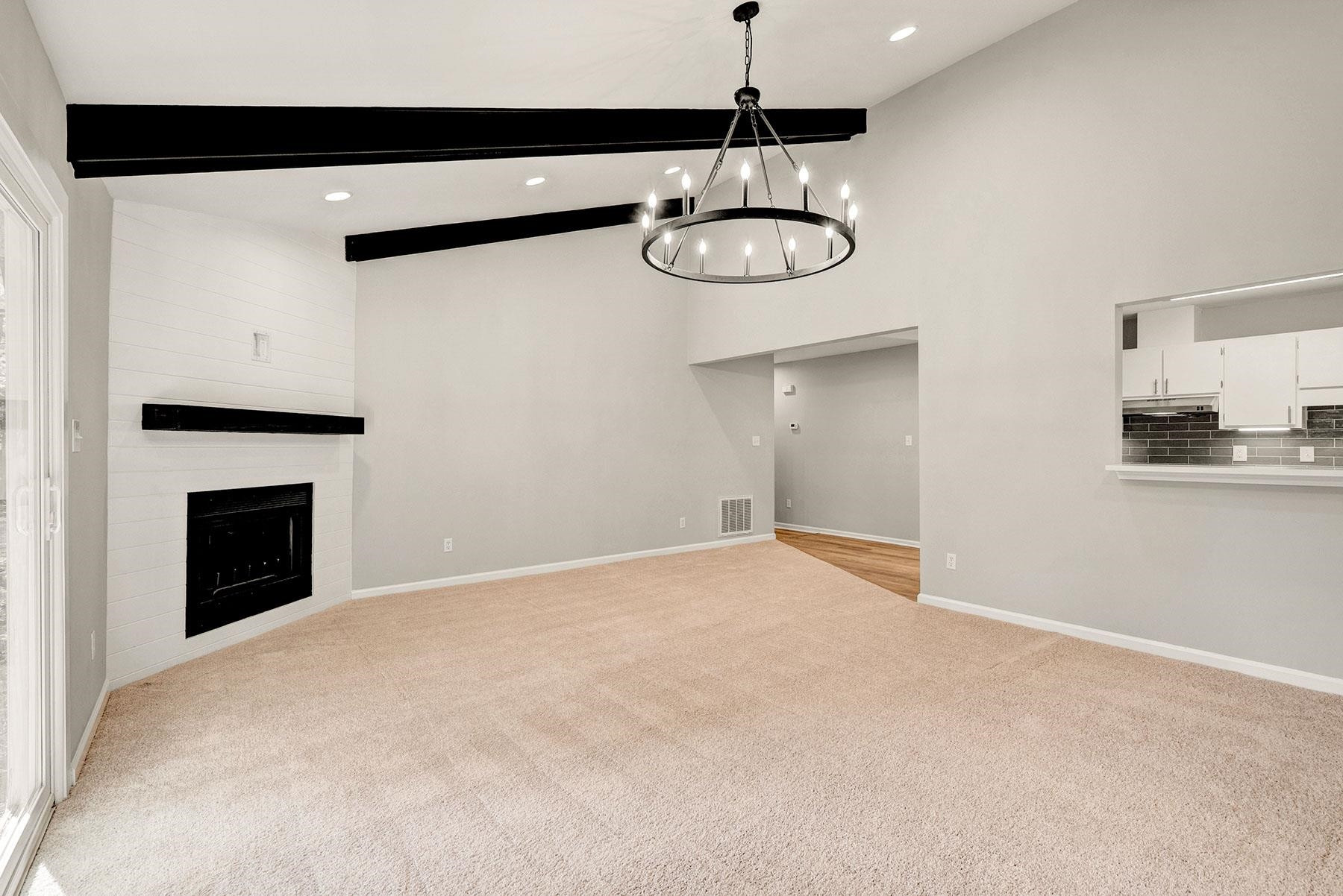 6500 Hammersmith Drive Raleigh, NC 27613 - Photo 12 of 21 a view of empty room with wooden floor and fireplace