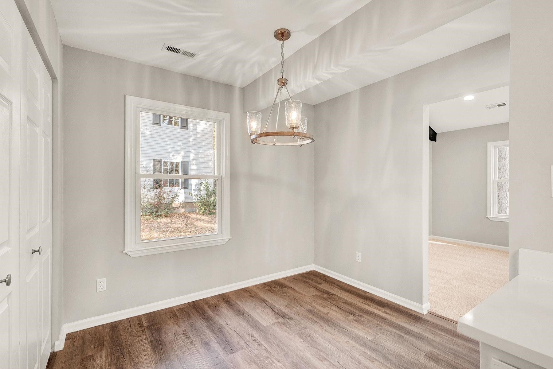 6500 Hammersmith Drive Raleigh, NC 27613 - Photo 8 of 21 a view of empty room with wooden floor and fan