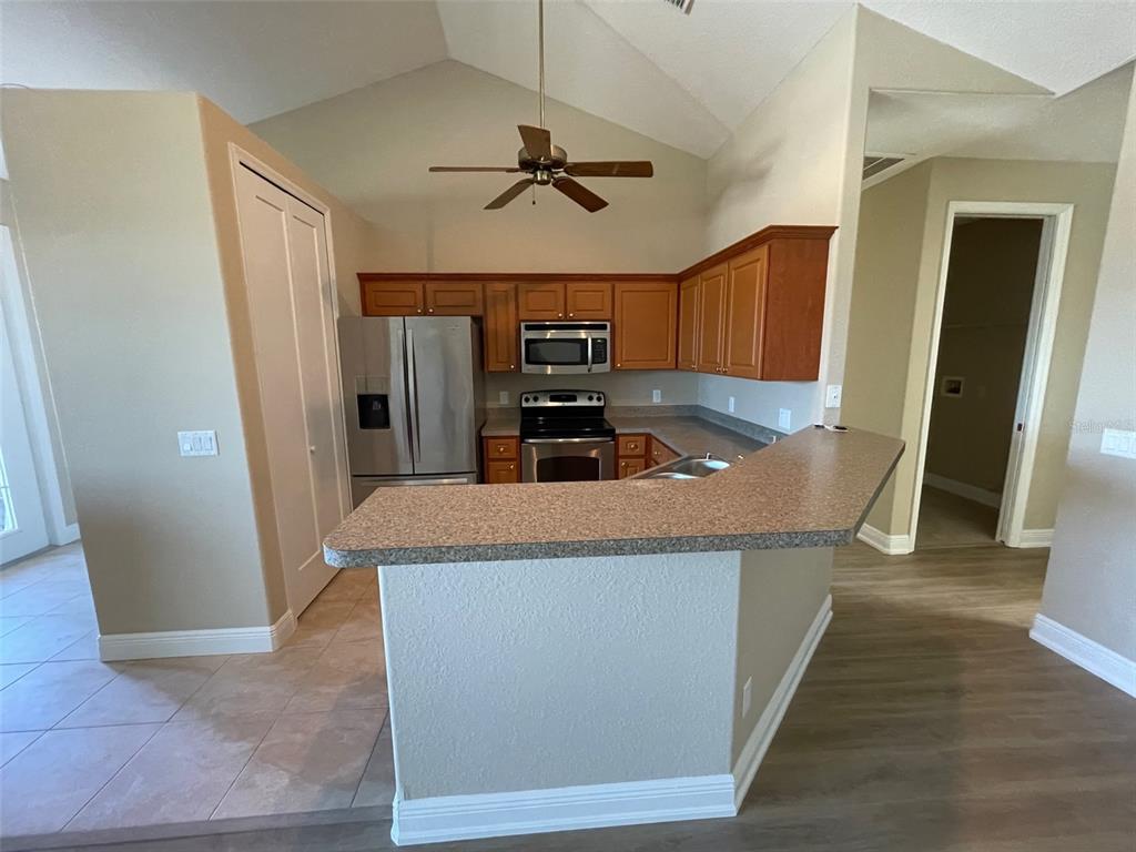 10365 Pendleton Avenue Englewood, FL 34224 - Photo 3 of 9 a kitchen with granite countertop a refrigerator and a sink