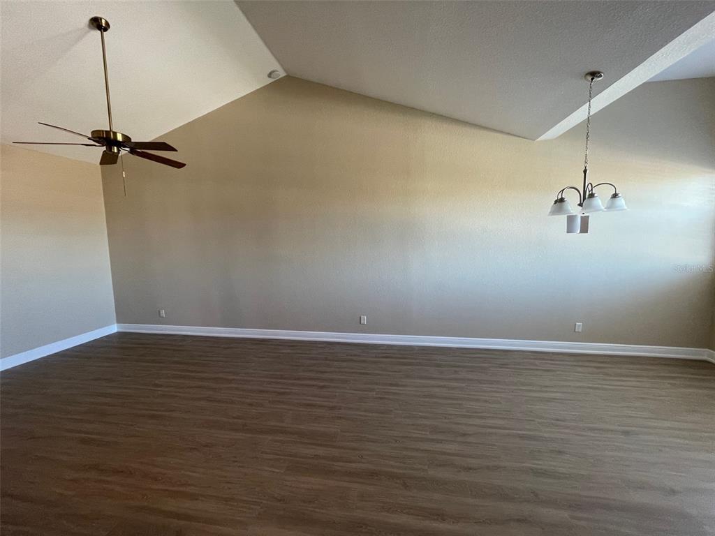 10365 Pendleton Avenue Englewood, FL 34224 - Photo 5 of 9 a view of a room with wooden floor and fan