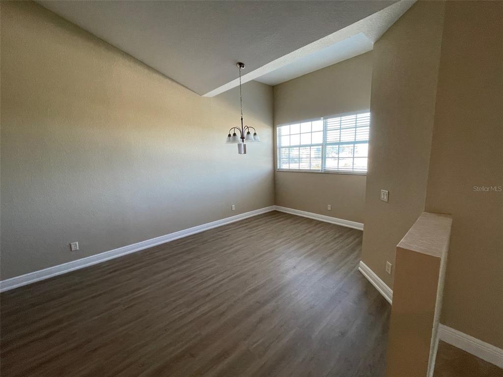10365 Pendleton Avenue Englewood, FL 34224 - Photo 6 of 9 wooden floor in an empty room with a window