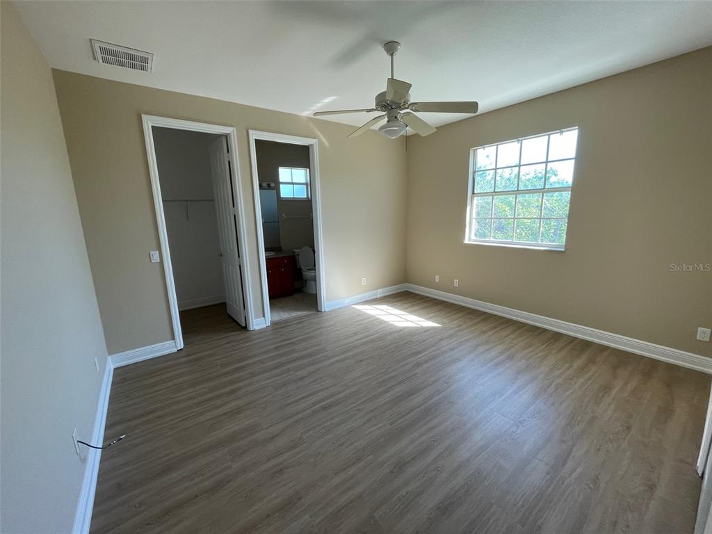 10365 Pendleton Avenue Englewood, FL 34224 - Photo 7 of 9 a view of an empty room with wooden floor and a window