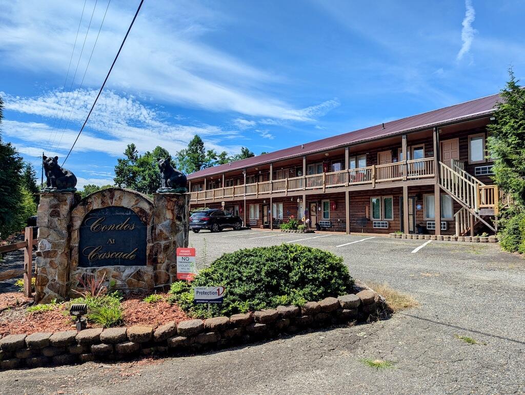 96 Cascade Trail, Unit 24 Fancy Gap, VA 24328 - Photo 1 of 18 a front view of a house with a garden