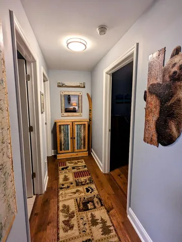 a bedroom with bed and wooden floor