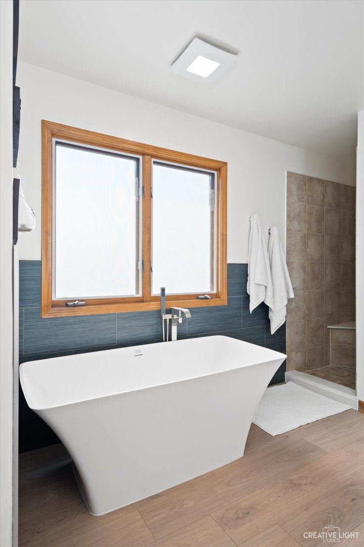 3812 Mistflower Lane Naperville, IL 60564 - Photo 21 of 49 a bath tub sitting in a bathroom next to a window