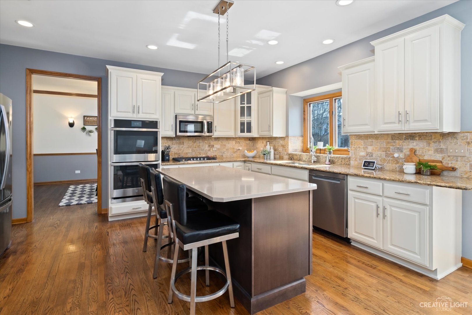 3812 Mistflower Lane Naperville, IL 60564 - Photo 3 of 49 a kitchen with a table chairs microwave and cabinets