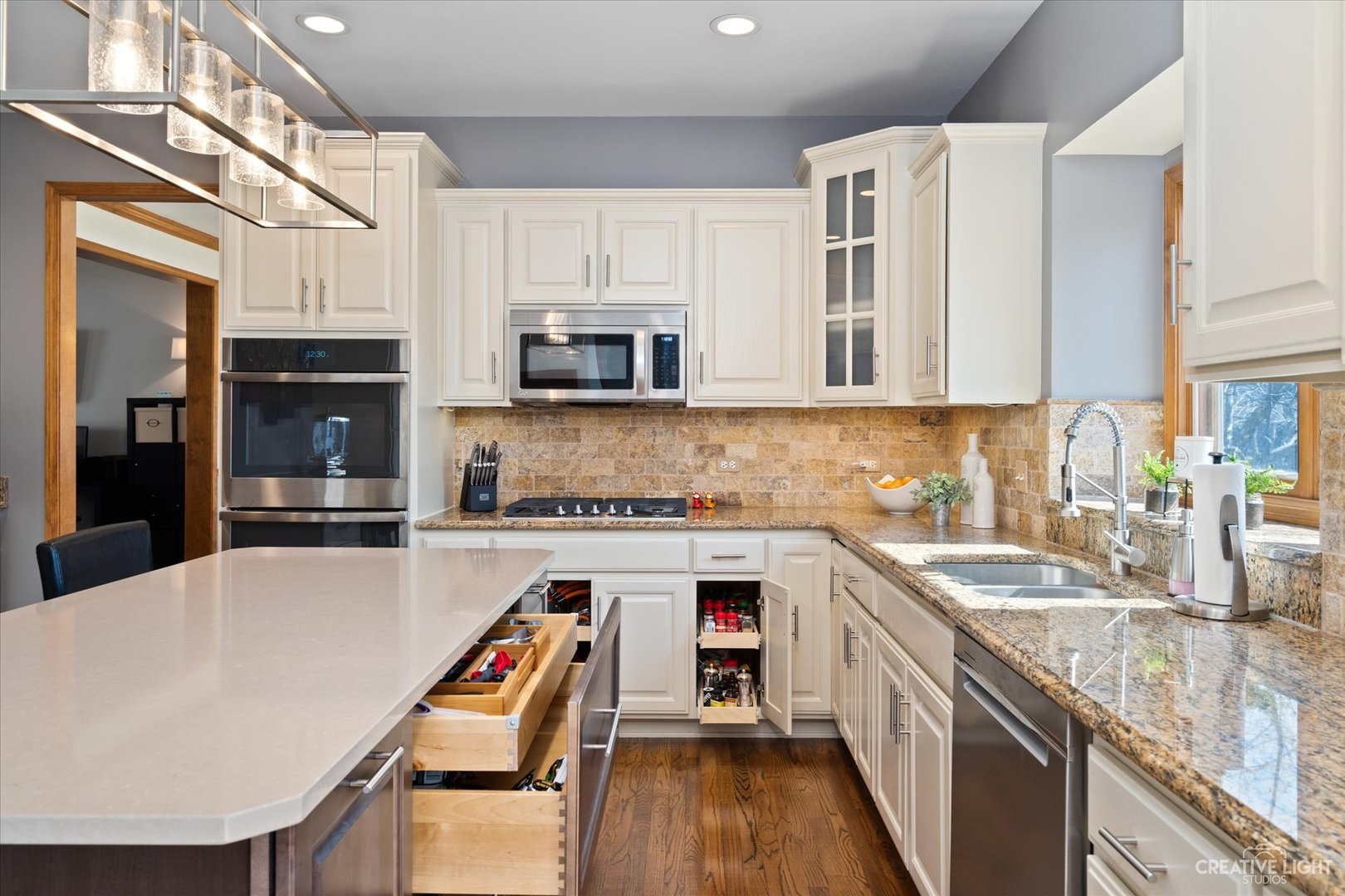 3812 Mistflower Lane Naperville, IL 60564 - Photo 5 of 49 a kitchen with stainless steel appliances granite countertop a sink stove microwave and refrigerator