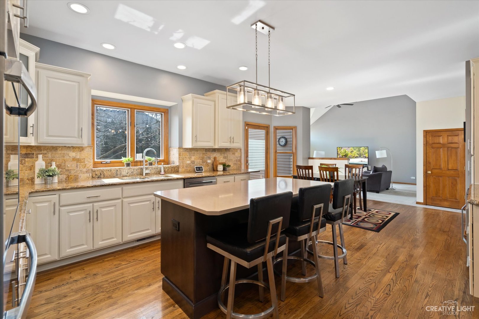3812 Mistflower Lane Naperville, IL 60564 - Photo 6 of 49 a open dining room with stainless steel appliances granite countertop a sink dishwasher a dining table and chairs with wooden floor