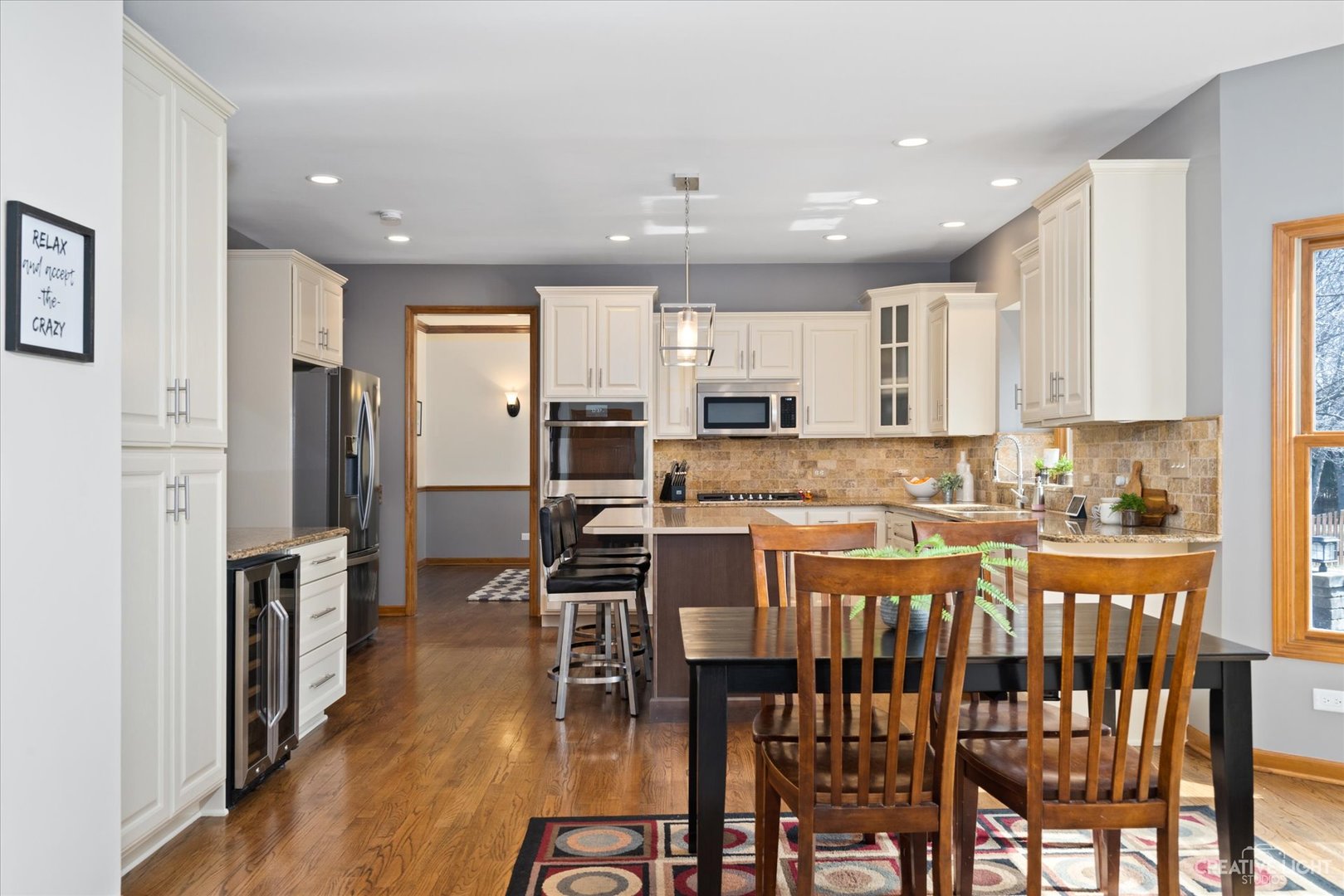 3812 Mistflower Lane Naperville, IL 60564 - Photo 7 of 49 a kitchen with stainless steel appliances kitchen island granite countertop a refrigerator a stove a dining table and chairs