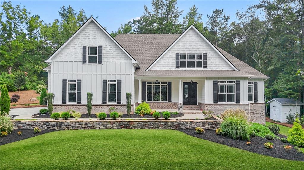 a front view of a house with a yard and potted plants
