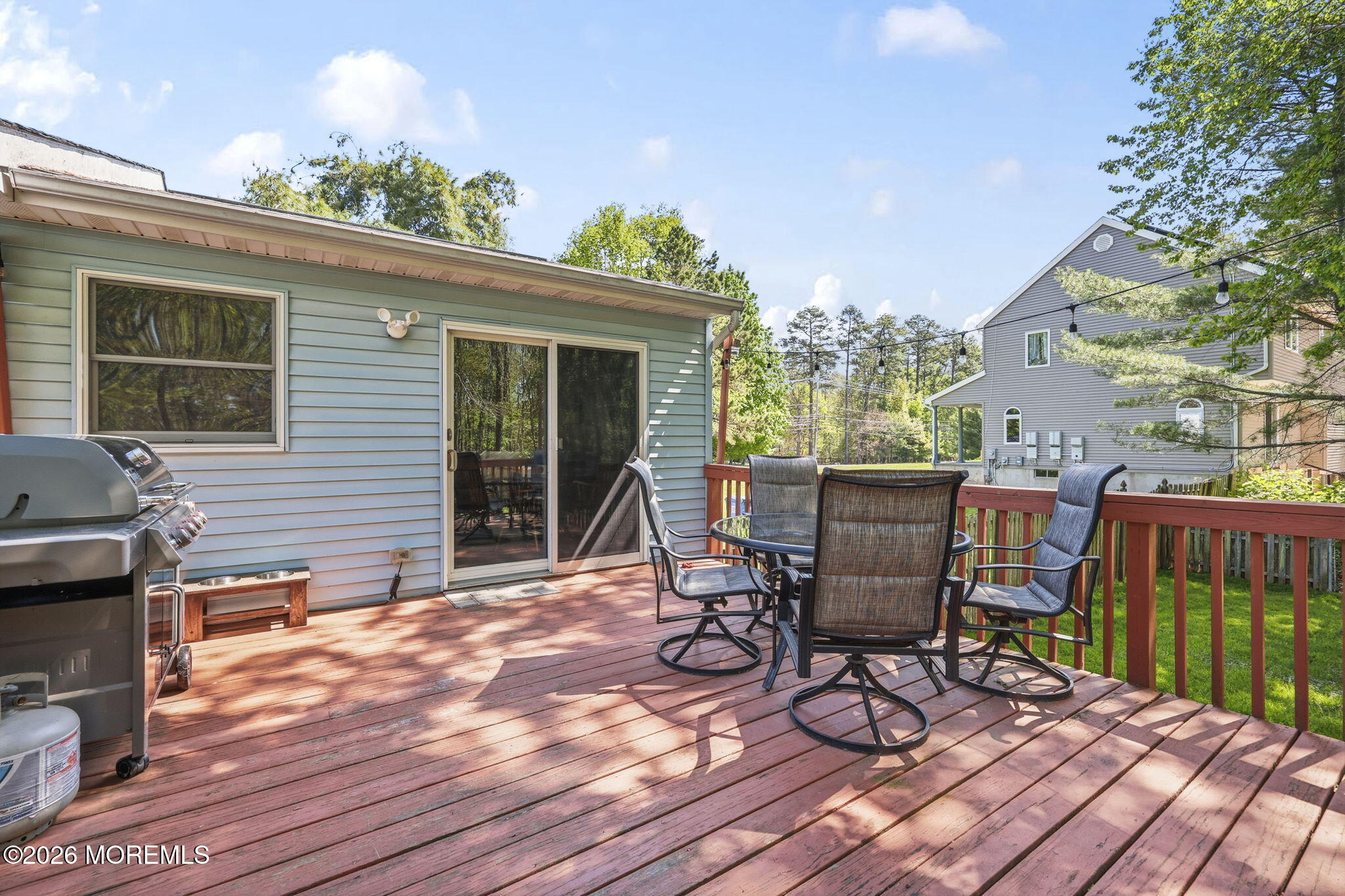 356 Leesville Road Jackson, NJ 08527 - Photo 33 of 46 a view of a patio with table and chairs and wooden floor