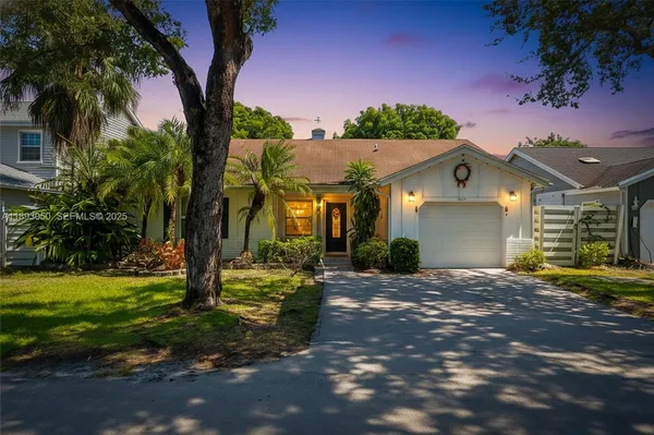 a view of a house with a tree in a yard
